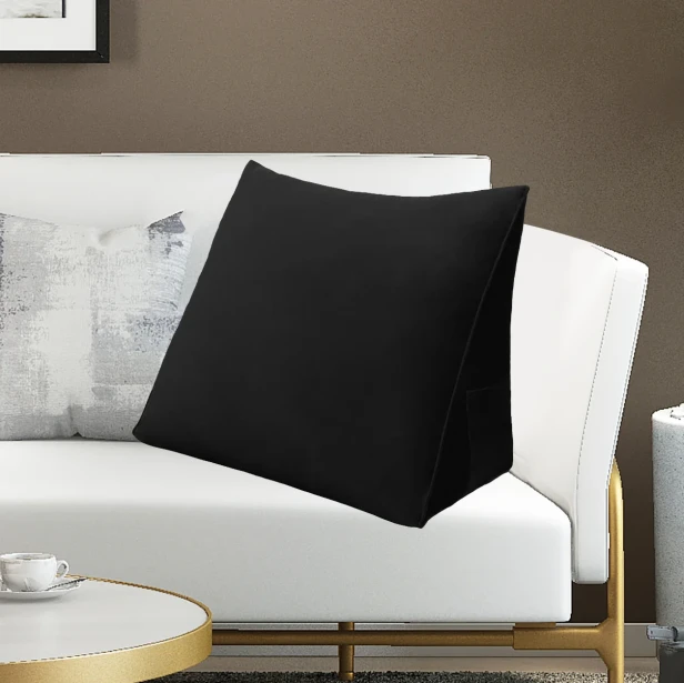 Schwarzes Rückenstützkissen, arrangiert im Wohnzimmer auf dem Sofa.
