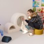 Frau spielt mit Katzen auf der Katzenkletterleiter.