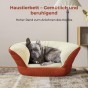 Der Hund liegt in einem großen, erhöhten Hundebett in Terrakotta und Beige.