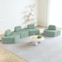 Set aus vier modularen, halbrunden Ecksofas, angeordnet im Wohnzimmer.